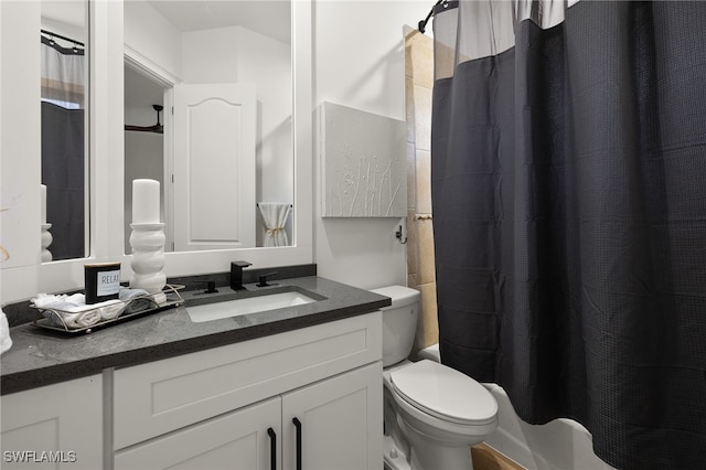 bathroom featuring toilet, vanity, and walk in shower