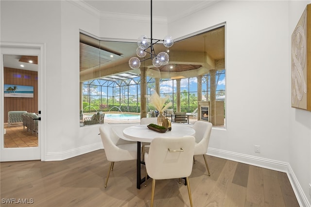 dining room featuring hardwood / wood-style floors and crown molding