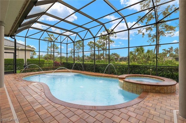 view of pool featuring pool water feature, a lanai, an in ground hot tub, and a patio