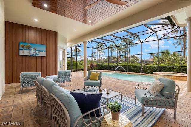 view of patio with an outdoor living space, pool water feature, a pool with hot tub, ceiling fan, and a lanai