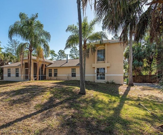 back of property featuring a lawn