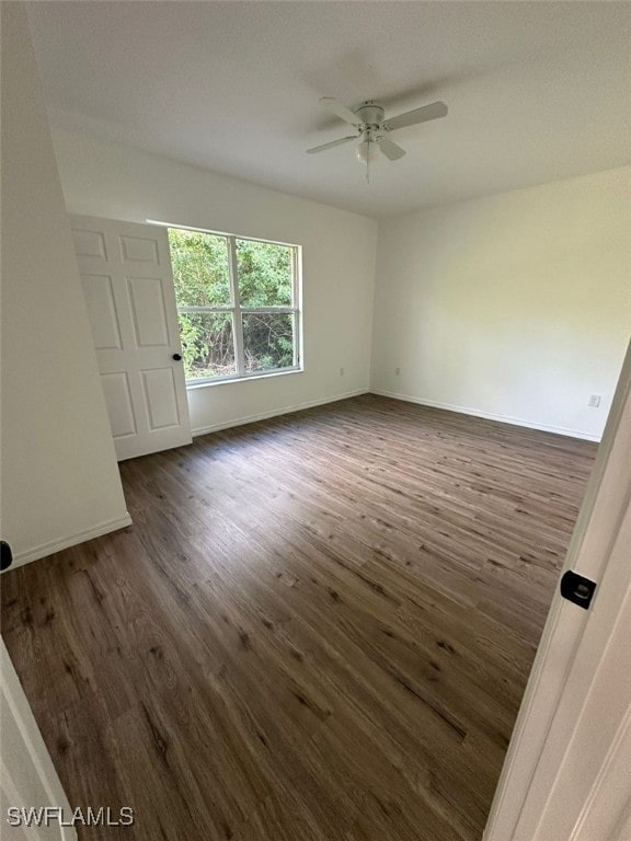 spare room with ceiling fan and dark hardwood / wood-style floors