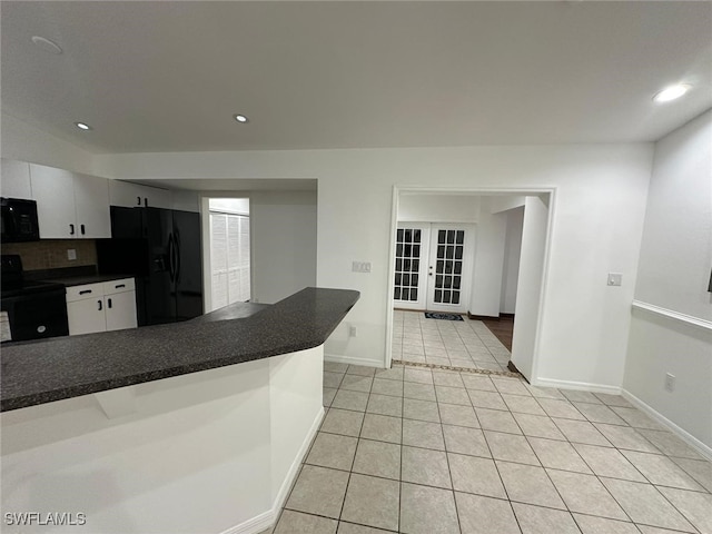 kitchen with white cabinets, decorative backsplash, black appliances, light tile patterned floors, and french doors