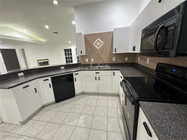 kitchen with lofted ceiling, sink, kitchen peninsula, white cabinetry, and black appliances