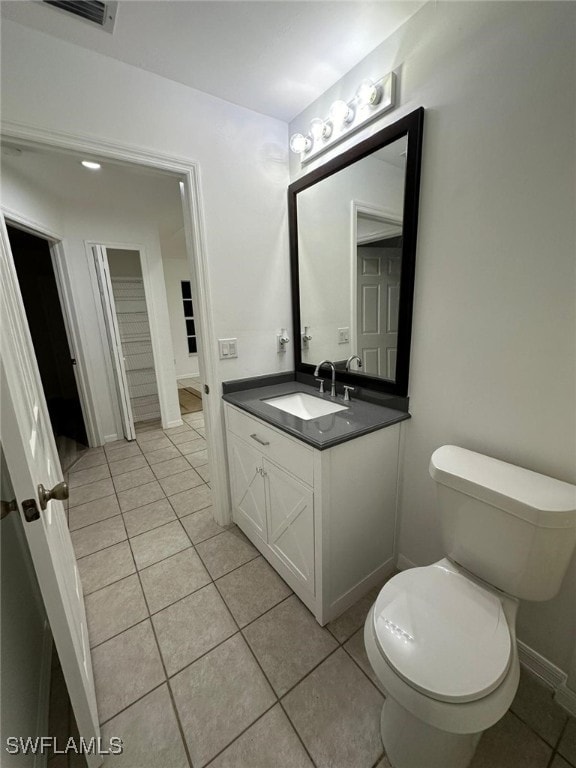 bathroom featuring vanity, toilet, and tile patterned floors