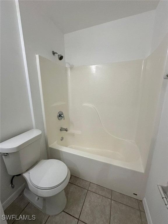 bathroom with shower / tub combination, tile patterned floors, and toilet