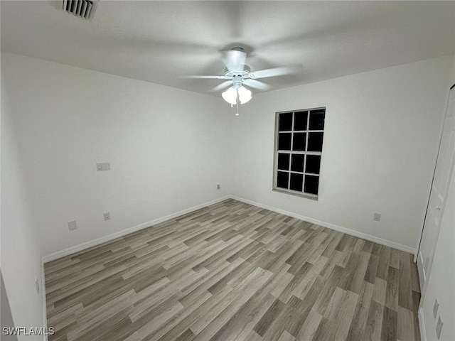 spare room with ceiling fan and light hardwood / wood-style floors