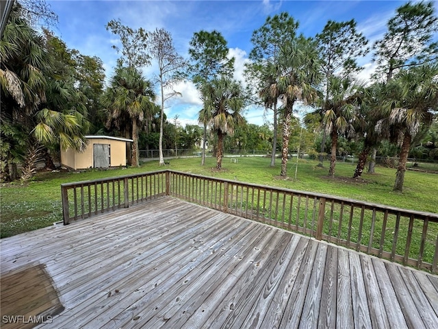 wooden deck with a shed and a yard