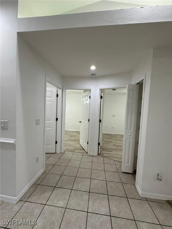 hall featuring light tile patterned floors