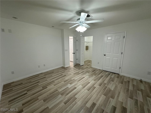 unfurnished room with ceiling fan and light hardwood / wood-style flooring