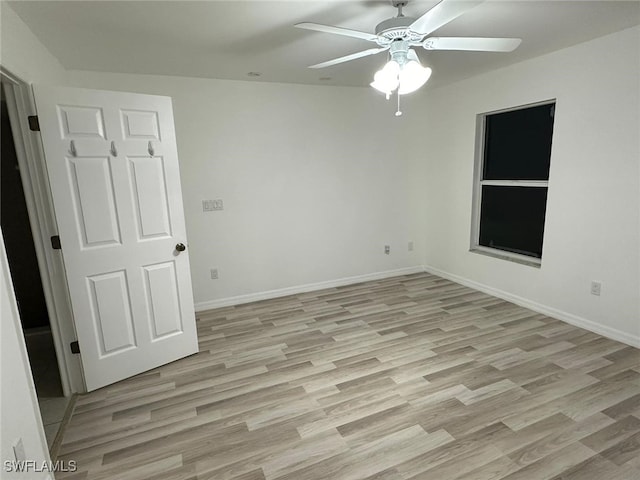 spare room featuring ceiling fan and light hardwood / wood-style flooring