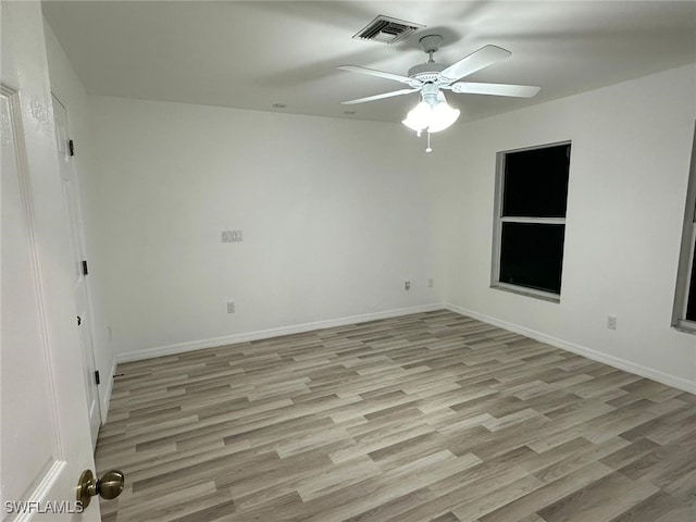 unfurnished room with light wood-type flooring and ceiling fan