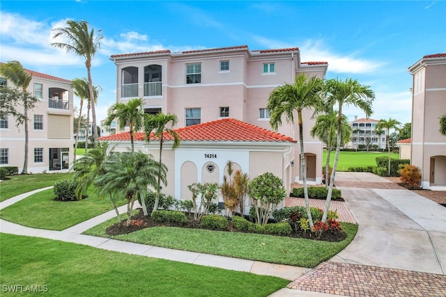 mediterranean / spanish home featuring a front yard