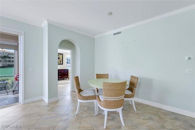 dining area featuring light tile patterned floors and ornamental molding