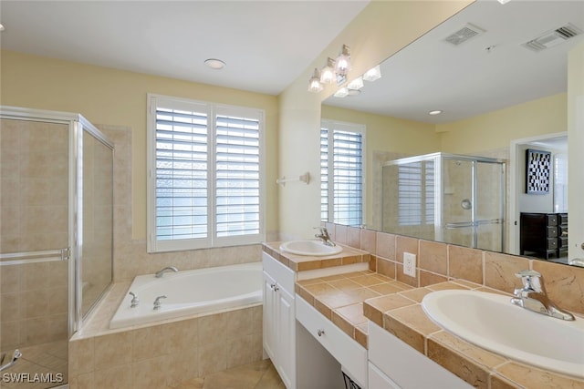 bathroom with independent shower and bath, vanity, and tile patterned floors