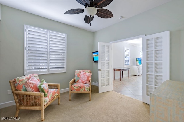 sitting room featuring light tile patterned flooring, ceiling fan, and french doors