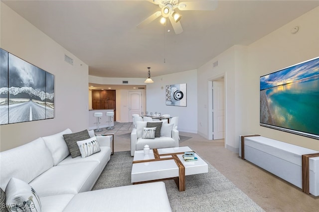 carpeted living room featuring ceiling fan