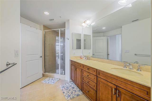 bathroom featuring tile patterned floors, vanity, and walk in shower