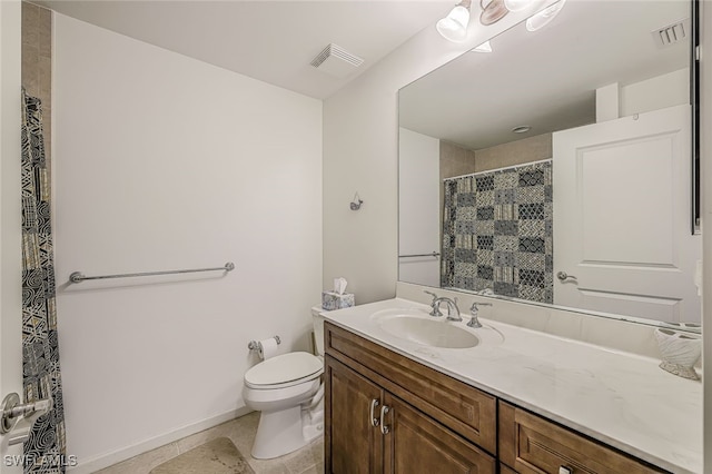 bathroom featuring tile patterned flooring, vanity, and toilet