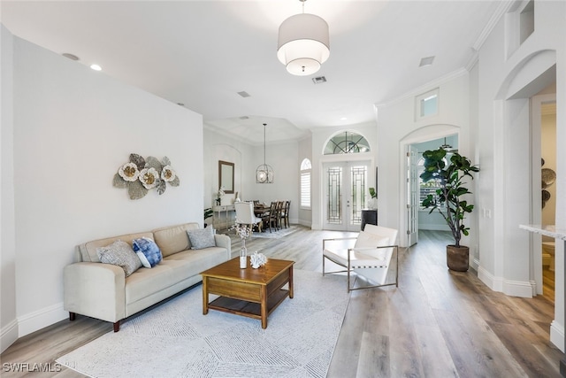 living room with crown molding and hardwood / wood-style flooring