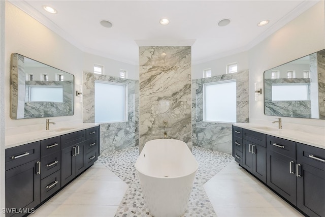 bathroom featuring vanity, a healthy amount of sunlight, and tile walls