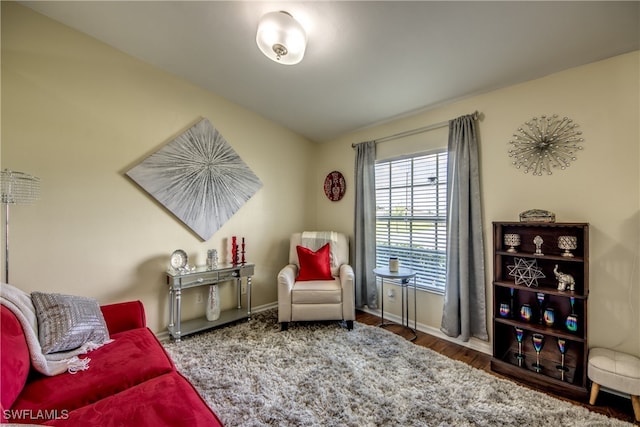 sitting room featuring lofted ceiling and hardwood / wood-style floors