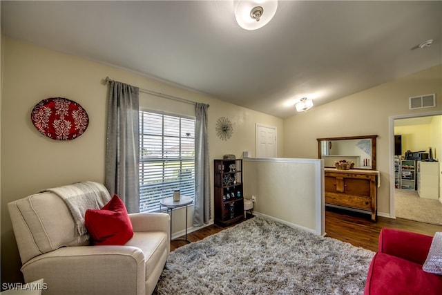 living room with lofted ceiling and dark wood-type flooring