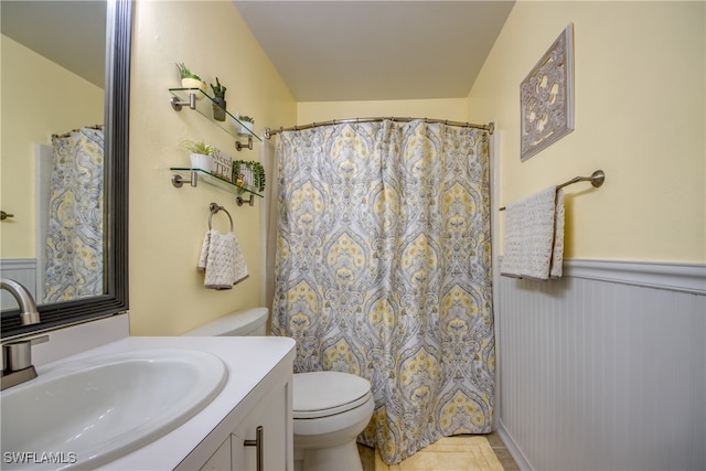 bathroom with walk in shower, vanity, and toilet