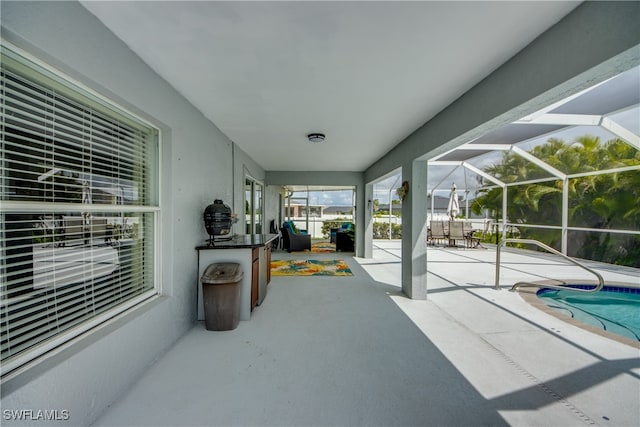 view of patio / terrace featuring a lanai