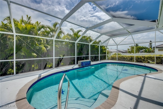 view of swimming pool with pool water feature, a patio, and glass enclosure