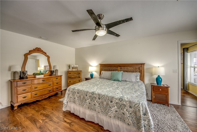 bedroom featuring ceiling fan and dark hardwood / wood-style flooring