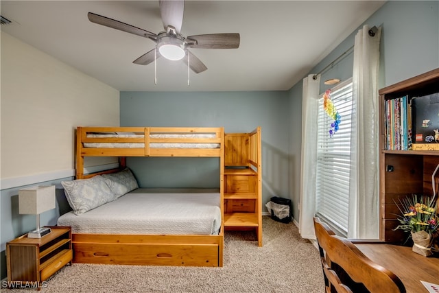 bedroom featuring ceiling fan and light carpet