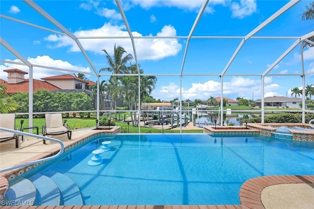 view of pool featuring glass enclosure, a water view, an in ground hot tub, and a patio area