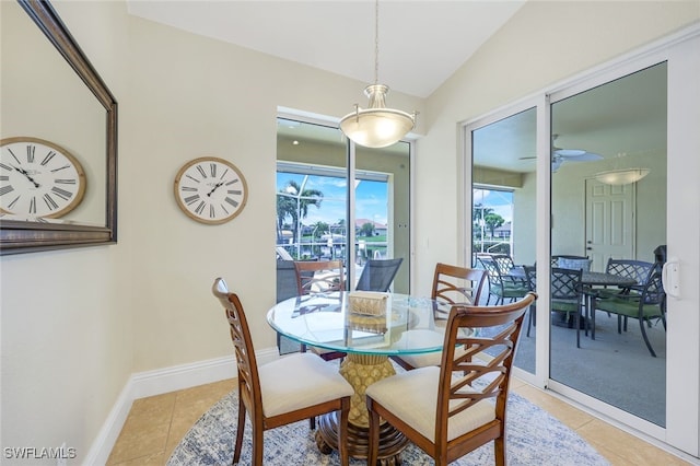 tiled dining area featuring lofted ceiling