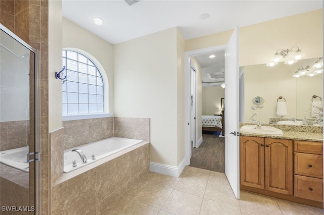 bathroom featuring tile patterned floors, independent shower and bath, and vanity