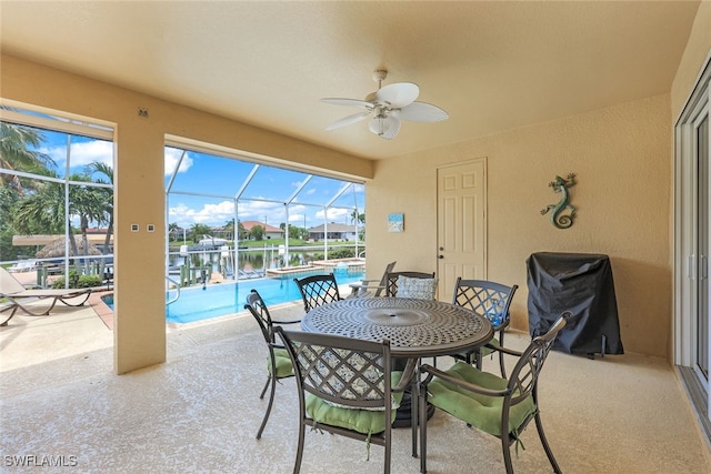 exterior space featuring a water view, a lanai, and ceiling fan