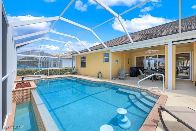 view of pool featuring a patio, glass enclosure, and ceiling fan