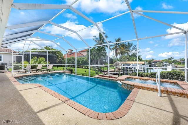 view of swimming pool with a water view, glass enclosure, an in ground hot tub, and a patio area