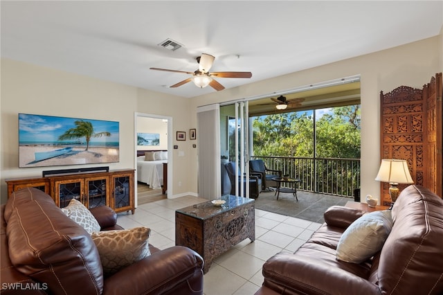 living room featuring ceiling fan and light tile patterned floors