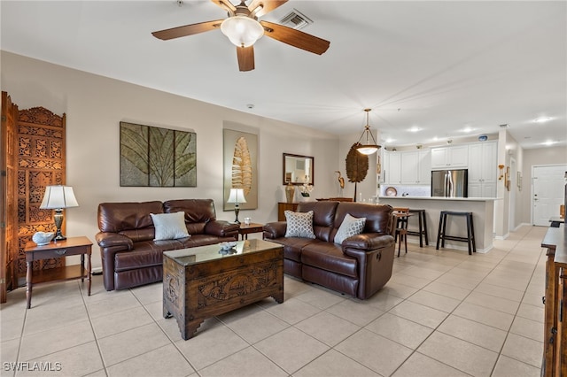 tiled living room with ceiling fan