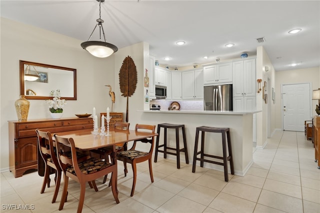 dining space with light tile patterned floors