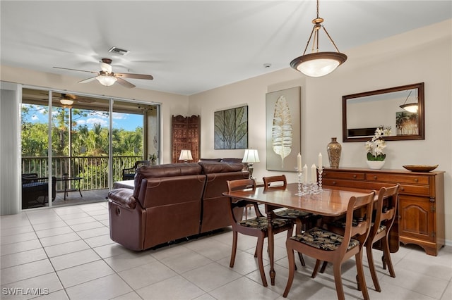 tiled dining area featuring ceiling fan