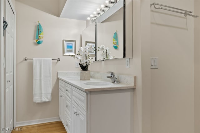 bathroom featuring vanity and hardwood / wood-style floors