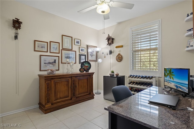 tiled office featuring ceiling fan