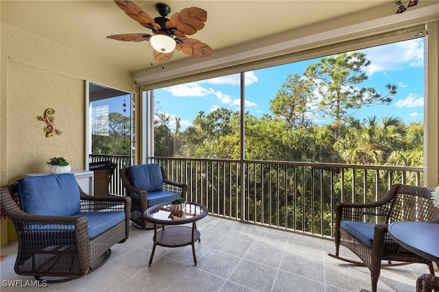 sunroom featuring ceiling fan