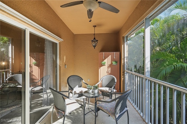 sunroom / solarium featuring ceiling fan