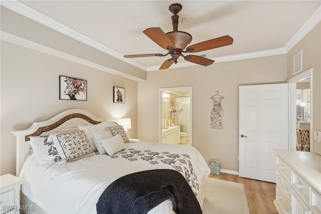 bedroom featuring ornamental molding, light wood-type flooring, ensuite bath, and ceiling fan