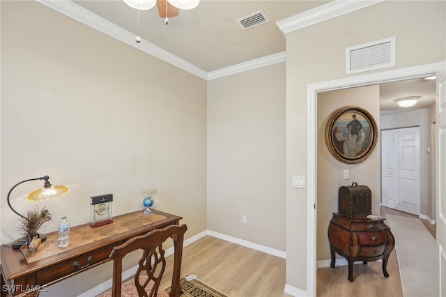 office area with light hardwood / wood-style floors, ornamental molding, and ceiling fan