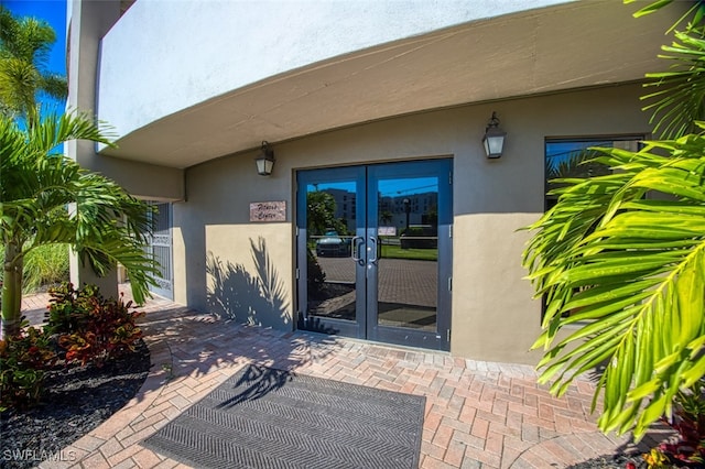 entrance to property featuring french doors and a patio area