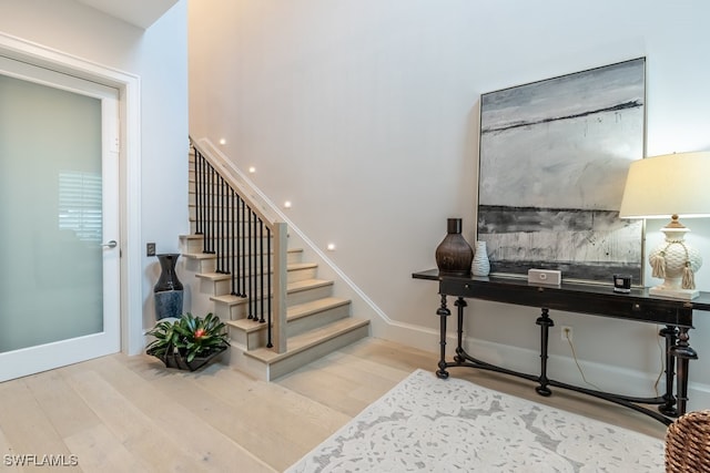 staircase featuring wood-type flooring